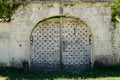 Old classic and weathered rustic wooden gate arch doors with rusty lock on ancient wood door access house Royalty Free Stock Photo