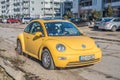 Old classic yellow Volkswagen New Beetle right side front view Royalty Free Stock Photo