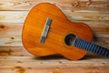 Old classical guitar on wooden background Royalty Free Stock Photo