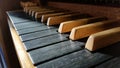 Old classy wooden musical instrument keyboard closeup, pipe organ manual, keys macro, dramatic high contrast lighting Royalty Free Stock Photo