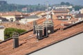 Old clay chimney pots and brick chimney stacks on old tiled roof complete with TV aerials in England, UK. Royalty Free Stock Photo