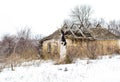 Old clay house in the Ukrainian village. Ruined clay house in the snow. Royalty Free Stock Photo