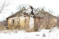 Old clay house in the Ukrainian village. Ruined clay house in the snow. Royalty Free Stock Photo