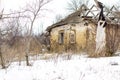 Old clay house in the Ukrainian village. Ruined clay house in the snow. Royalty Free Stock Photo