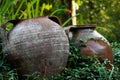 old clay pots on a green background placed in the garden for decoration Royalty Free Stock Photo