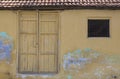 Old clay tiled roofing Kerala style house with vibrant yellow paint and rustic antique look taken in India.