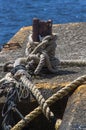 Old cleat and a big rope near the sea Royalty Free Stock Photo