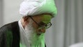 An old cleric prays at Qom Seminary in Qom, Iran