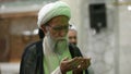 An old cleric prays at Qom Seminary in Qom, Iran