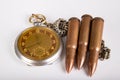 Old clock and ammunition on a white table. Explosive material and time measure Royalty Free Stock Photo