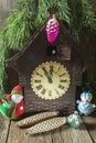 Old clock with Christmas toys under the Christmas tree Royalty Free Stock Photo