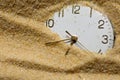 Old clock face in sand Royalty Free Stock Photo