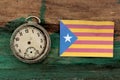 old clock and flag of Catalonia on wood background