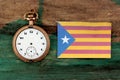 old clock and flag of Catalonia on wood background