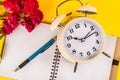 Old clock, red rose flower, pen on notebook, retro concept image Royalty Free Stock Photo