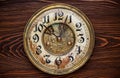 Old clock with a rusty clock face on wooden background Royalty Free Stock Photo