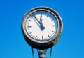 Old clock at a train station with blue sky in the background Royalty Free Stock Photo