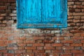 Old closed blue window with cracks. Brick wall Royalty Free Stock Photo
