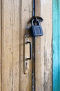 Old closed door with padlock and knob Royalty Free Stock Photo