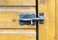 old closed latch on the wooden door, cobwebs on the latch Royalty Free Stock Photo