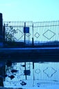 Old closed metal gates and their reflection in the water. Symbolism. Thoughtfulness. I