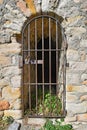 Old closed rusty iron gate in arch door of castle brick wall Royalty Free Stock Photo