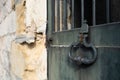 Old closed weathered green metal door with bar in a limestone wall Royalty Free Stock Photo