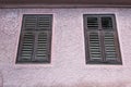 Old, closed windows with wood frame on old abandoned house in the city center Royalty Free Stock Photo