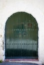 The old closed wooden door in white stone wall Royalty Free Stock Photo