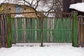 Old closed wooden green gate in the street Royalty Free Stock Photo