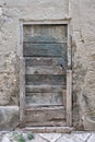 Old closed wooden rectangular door, chain and lock Royalty Free Stock Photo