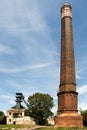 Old coal mine shaft with a mining tower in the foreground tall chimney Royalty Free Stock Photo