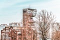 Old coal mine shaft tower with skyscrapers in the background Royalty Free Stock Photo