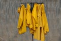 Raincoats hanging on an old rusty rack