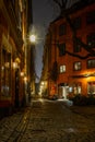 Old cobbled narrow street in Stockholm at night Royalty Free Stock Photo