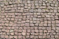 Old cobblestone pavement, paved with reddish stones, historical and architectural texture for background