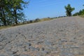 Old cobblestone road paved with stones Royalty Free Stock Photo