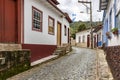 Old cobblestone street with houses in colonial architecture Royalty Free Stock Photo