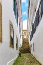 Old cobblestone street with houses in colonial architecture Royalty Free Stock Photo