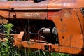 Old Cockshutt tractor buried in the weeds Royalty Free Stock Photo