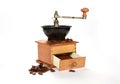 Old coffee grinder with coffee beans isolated on a white background Royalty Free Stock Photo