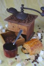 Old coffee grinder, cup, spoon and sugars. Chocolate bread Royalty Free Stock Photo