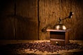 Old coffee grinder with fresh roasted beans on rustic old vintage oak background Royalty Free Stock Photo