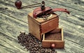 Old coffee grinder with ground coffee. Royalty Free Stock Photo