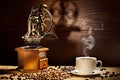 Old coffee mill and cup on wooden background