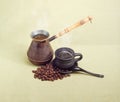 Old coffee pot, black ceramic cup with coffee, coffee beans Royalty Free Stock Photo