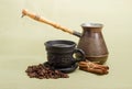 Old coffee pot, black cup with coffee, cinnamon, coffee beans Royalty Free Stock Photo