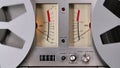 Old coil tape recorder with magnetic tape on reels. Controls panel, dashboard with measuring scale and arrows. Reels Royalty Free Stock Photo