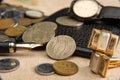 Old coins, fountain pen, wallet, cufflinks and more on a rustic wooden surface, selective focus Royalty Free Stock Photo