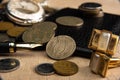 Old coins, fountain pen, wallet, cufflinks and more on a rustic wooden surface, selective focus Royalty Free Stock Photo